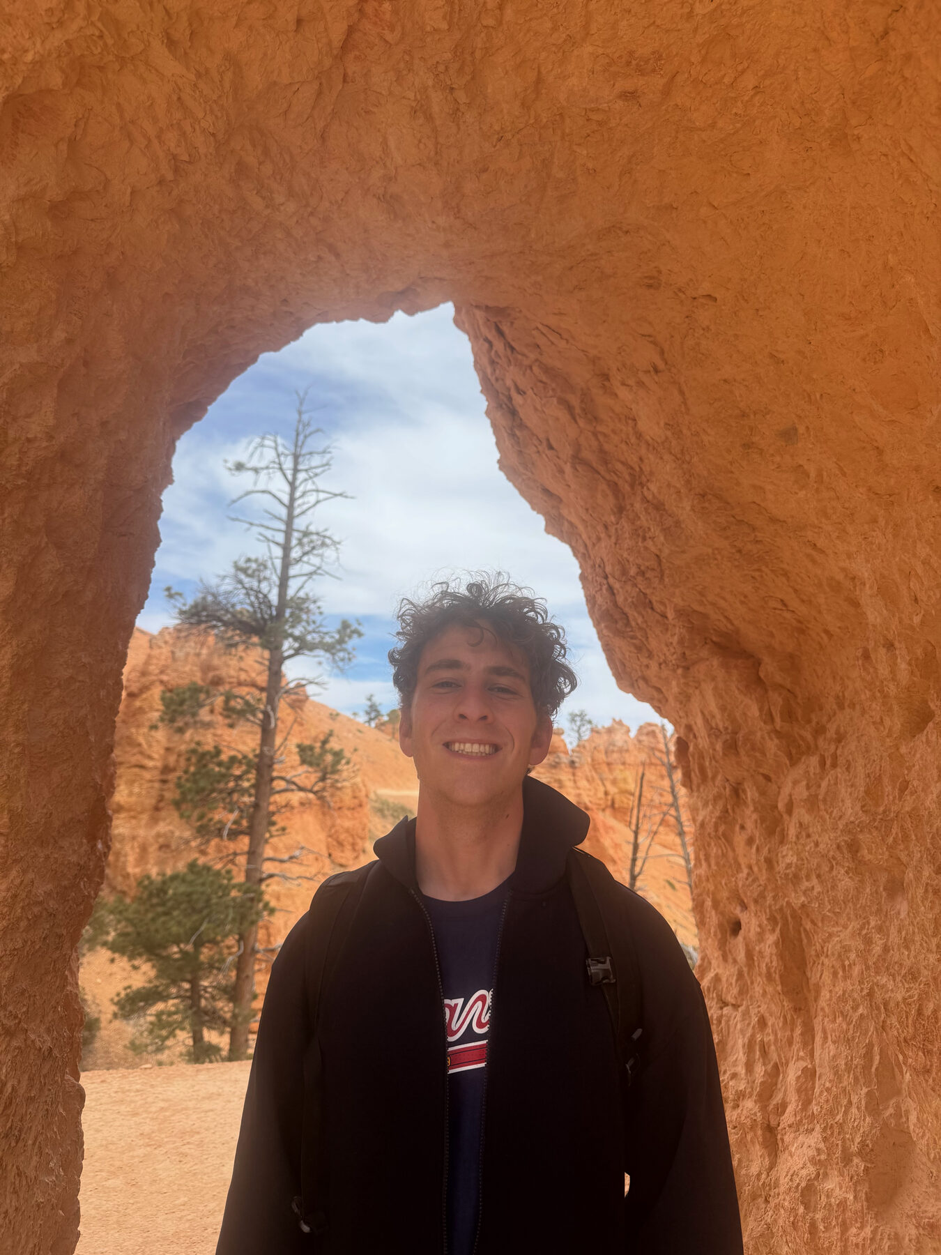 Hiker framed by a rock window in Bryce Canyon