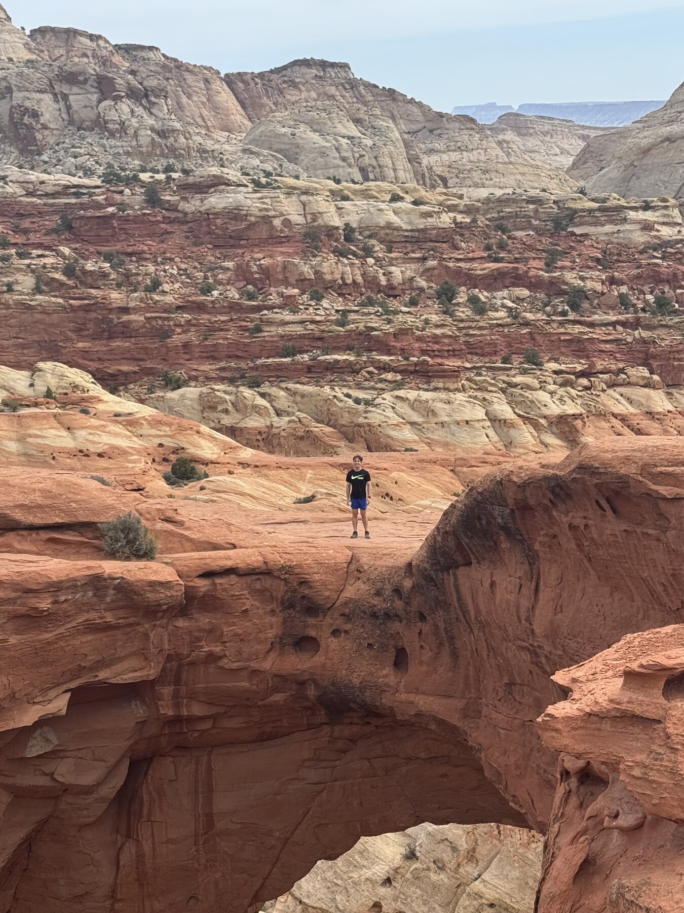 Zach standing above Cassidy Arch in Capitol Reef